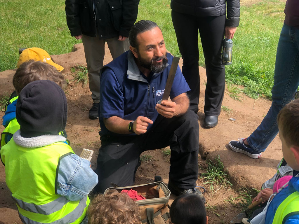 Presidio archaeologist giving explanation to children and adults at site