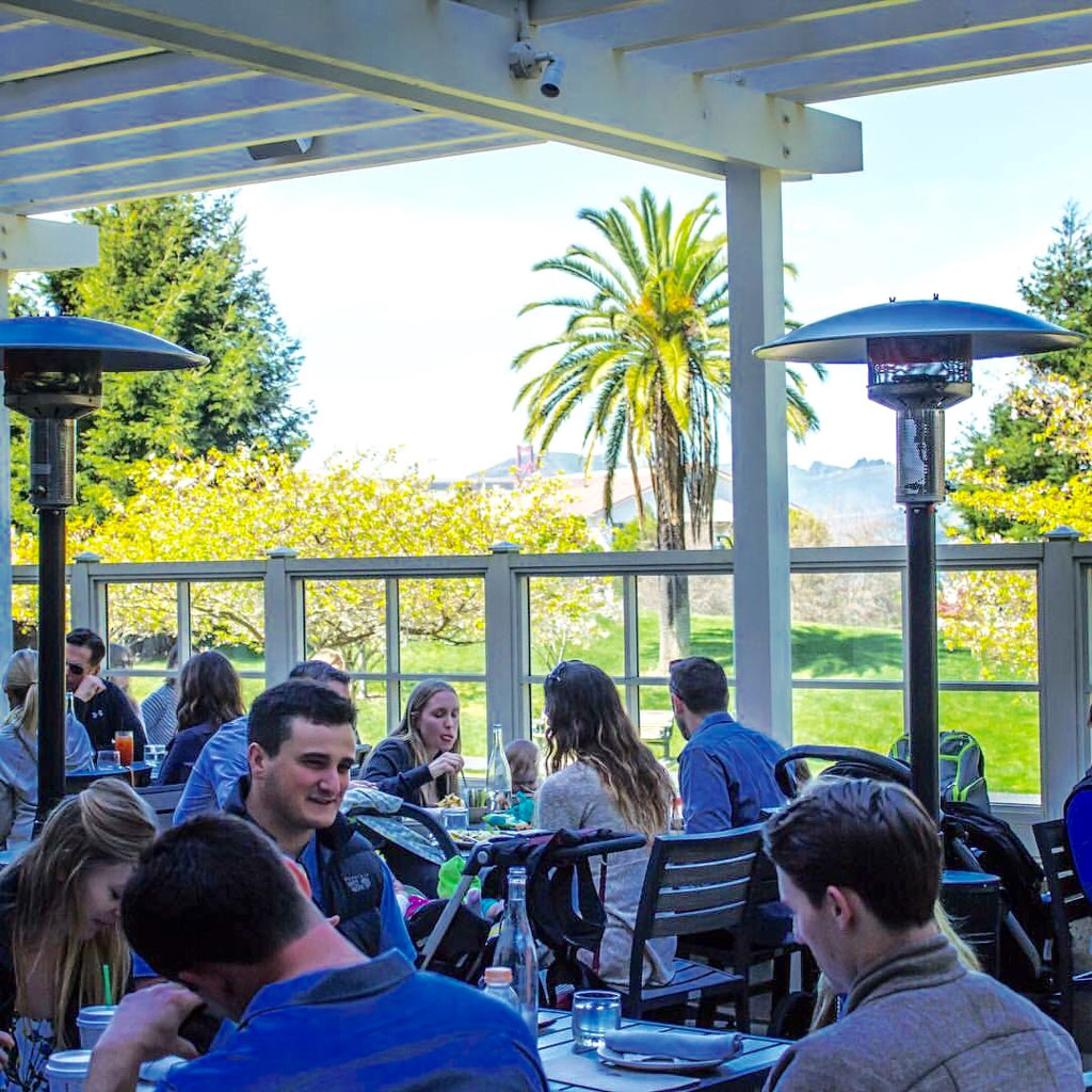 Visitors seated on shaded outdoor patio