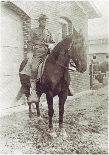 A black cavalryman at the Presidio stables, circa. 1915.