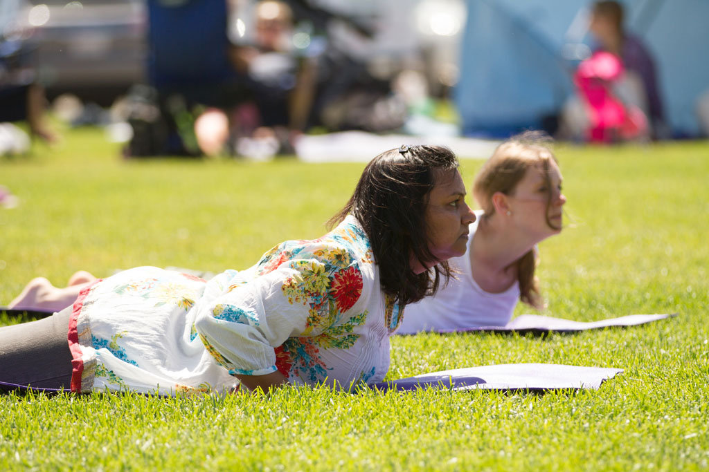 A couple Yoga class attendees on mats on Main Parade Lawn