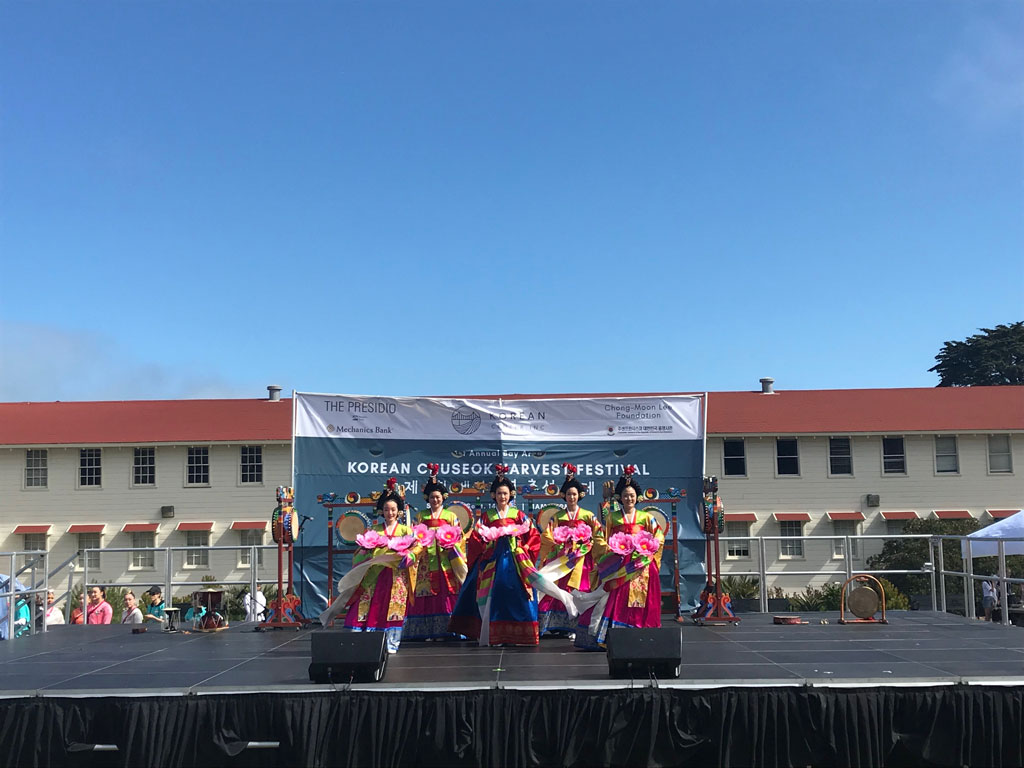 Performers in traditional outfits on stage