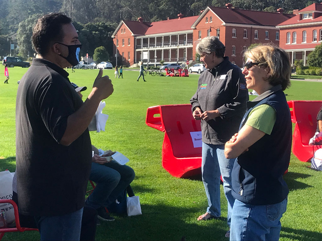 Man and woman speaking at Main Parade Lawn