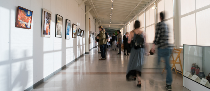 People visiting an art gallery at Tides Converge.