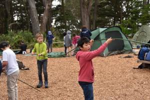 Several children setting up tents at Rob Hill Campground.