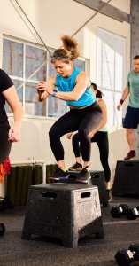 A woman jumping in an exercise class at CrossFit 7x7 in the Presidio. Photo courtesy of CrossFit 7x7.