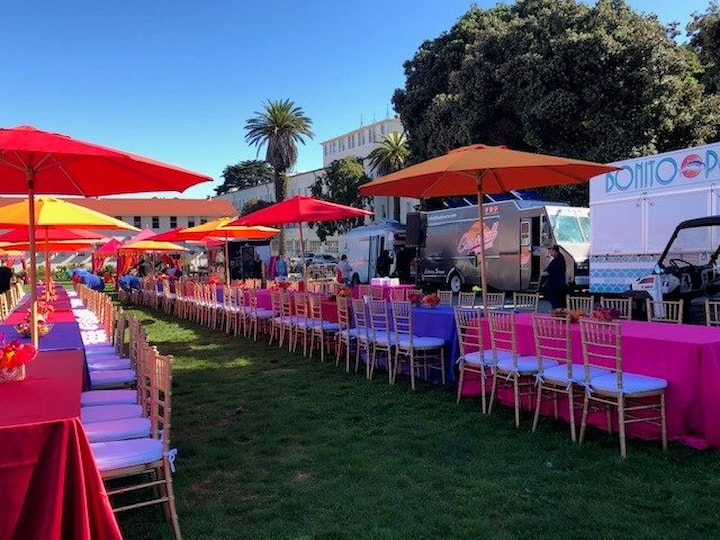 Tables with colorful decorations for a special event at the Civil War Parade Ground in the Presidio.