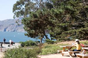 Woman sitting at the picnic area at the Immigrant Point Overlook in the Presidio.