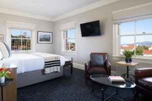 Room at the Inn with bed, TV, and sitting area. Photo by Paul Dyer.