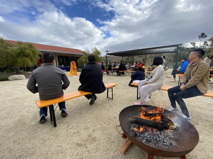 Four people from the Asian American for Civil Rights and Equality at the Crissy Field Center courtyard celebrating Lunar New Year.