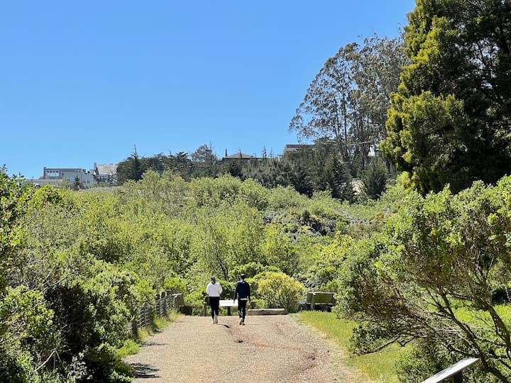 A man and woman walk at El Polin Spring in the Presidio.