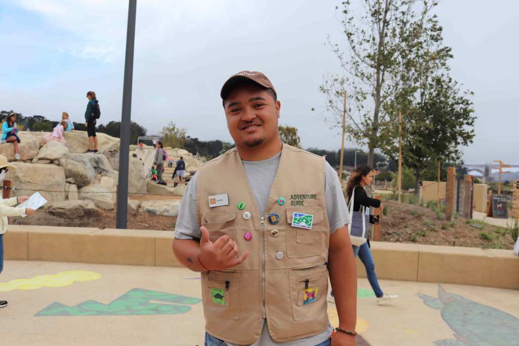 Dylan standing in front of the Outpost playground.