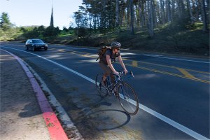 Bicyclist and vehicle on bike and car lanes, respectively