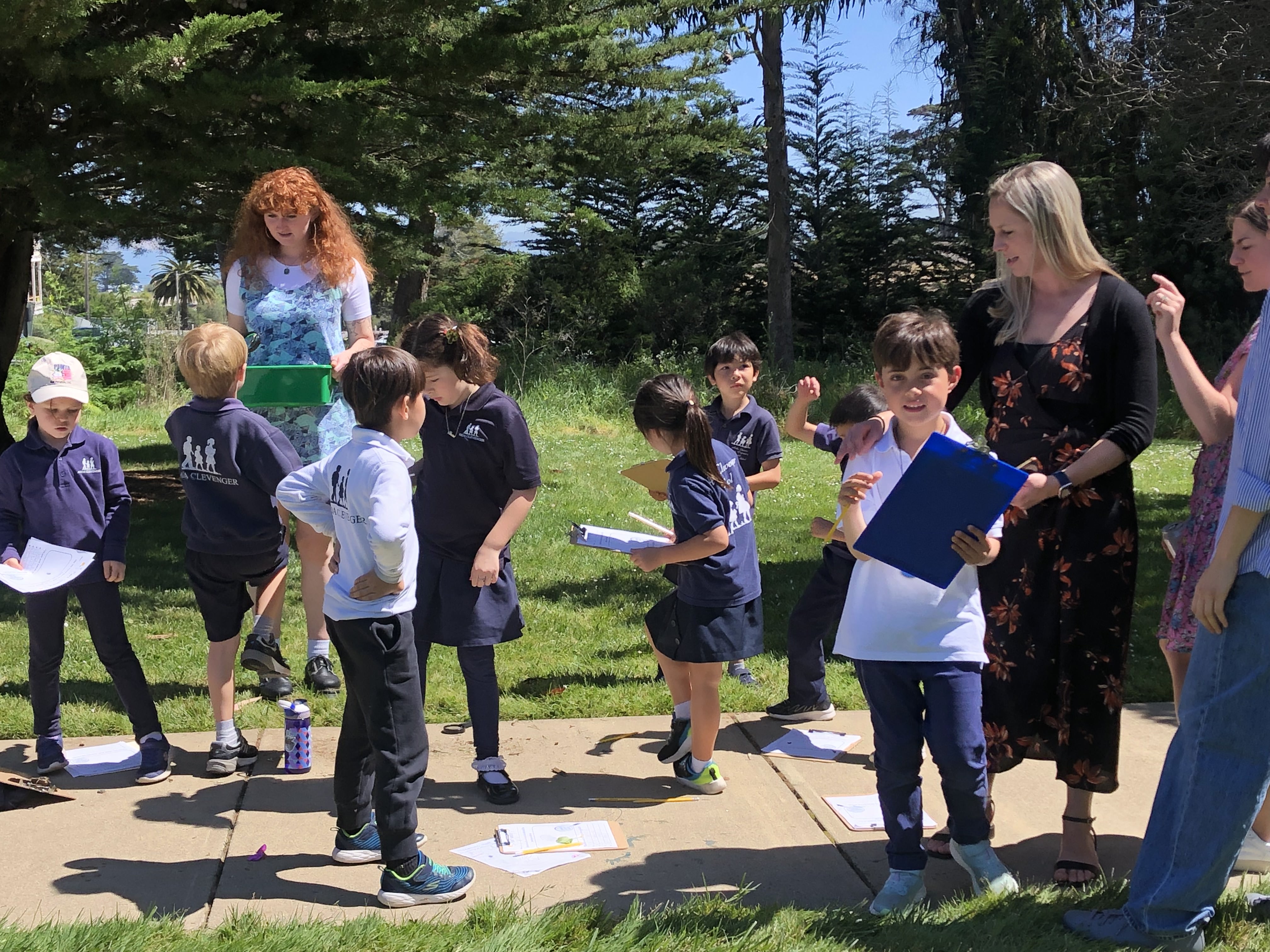 Group of kids and teacher standing outside